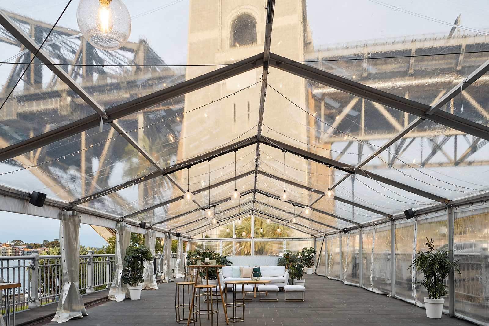 The marquee set for a daytime launch event beneath the Harbour Bridge pylon